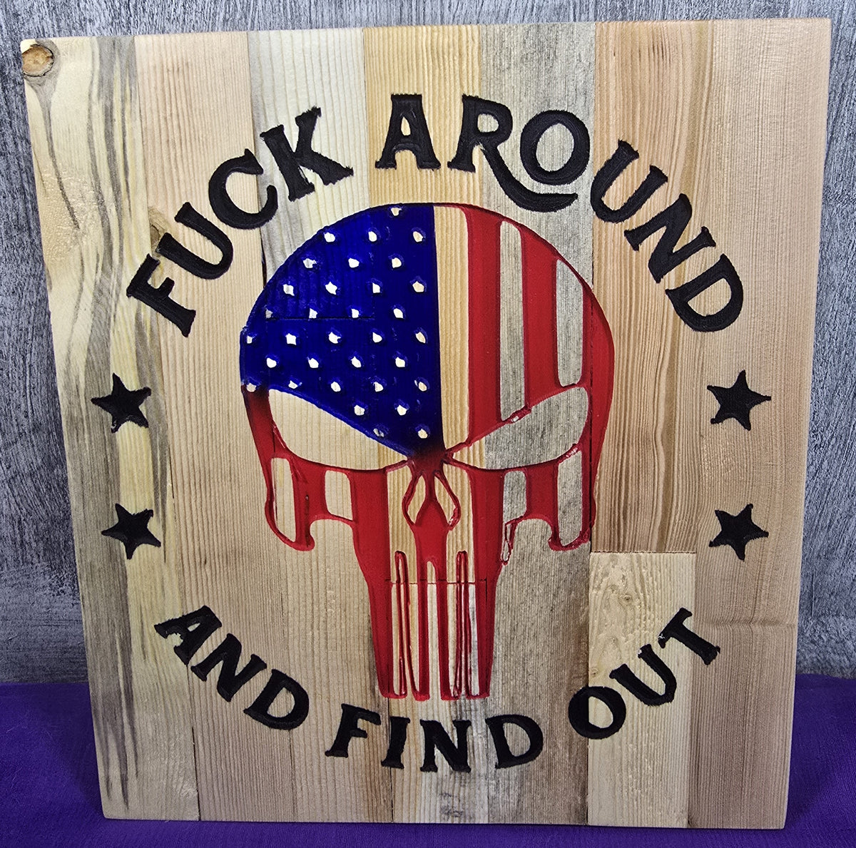 Wooden sign featuring a skull design with an American flag, text reads "F*** AROUND AND FIND OUT.