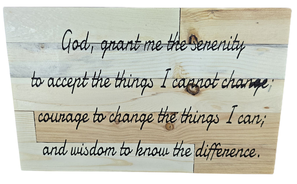 Wooden plaque with the Serenity Prayer inscribed in black cursive text on a light wood background.
