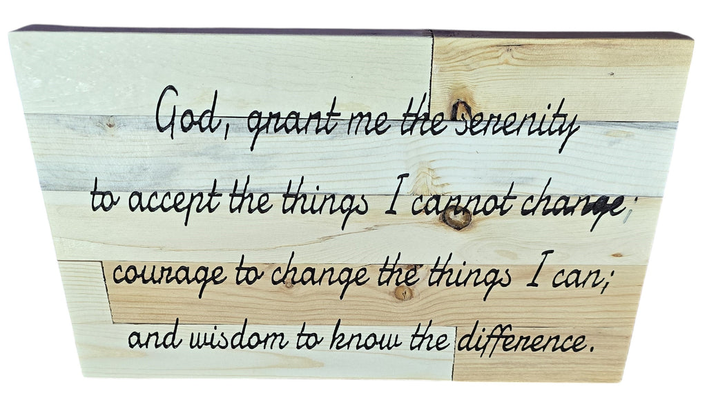 Serenity prayer wooden plaque with text in cursive on a light wood background.