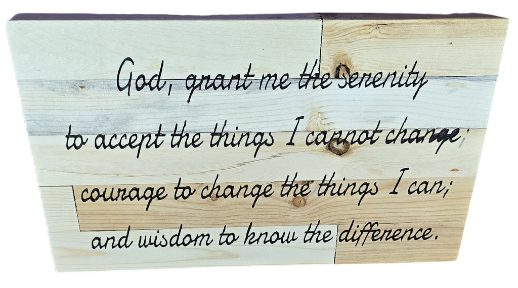 Wooden plaque displaying the Serenity Prayer in cursive black lettering on a light wood background.