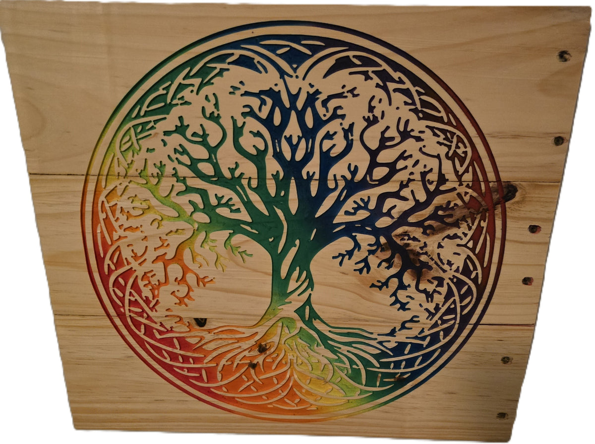 Rainbow tree of life design carved into wood, featuring intricate branches and roots in vibrant colors.