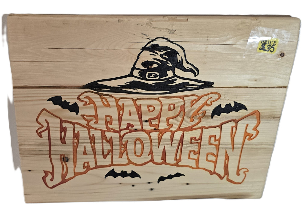 Wooden sign featuring "Happy Halloween" in orange text, with a witch's hat and bats, on a light wood background.