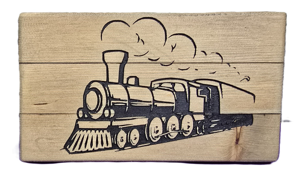 Wooden block featuring a detailed engraving of a vintage steam train with smoke clouds.