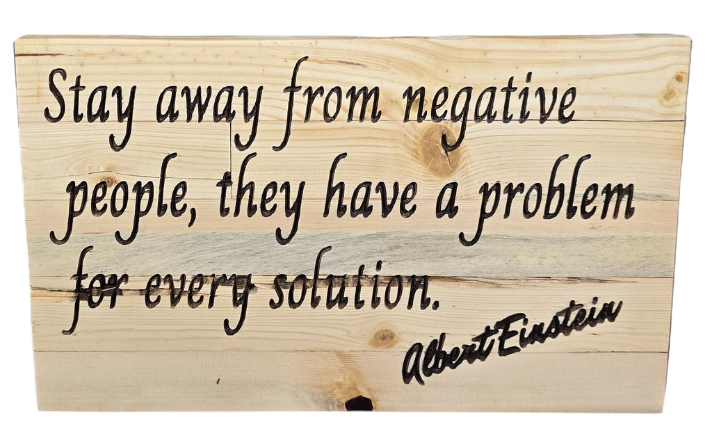TK Wood Designs natural wood wall art with Albert Einstein quote "Stay away from negative people, they have a problem for every solution." in black lettering.