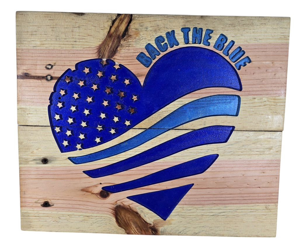 TK Wood Designs natural wood wall art featuring a blue heart with carved stars and stripes, and "BACK THE BLUE" lettering.