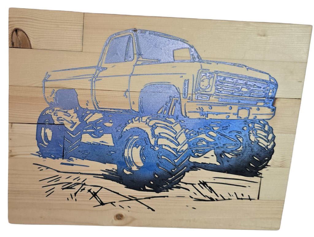 TK Wood Designs blue monster truck sign on wood, featuring oversized tires and a detailed grill.