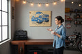 TK Wood Designs blue monster truck wood sign with large tires, displayed in a garage setting.