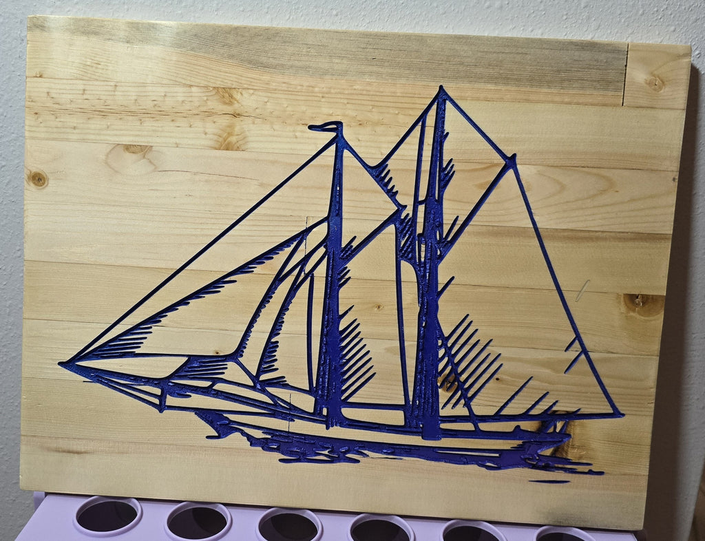 TK Wood Designs blue sailboat carved into light wood panel wall art