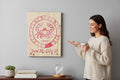 TK Wood Designs Cancer zodiac sign engraved on natural wood wall art with red crab symbol and dates on a grey wall.