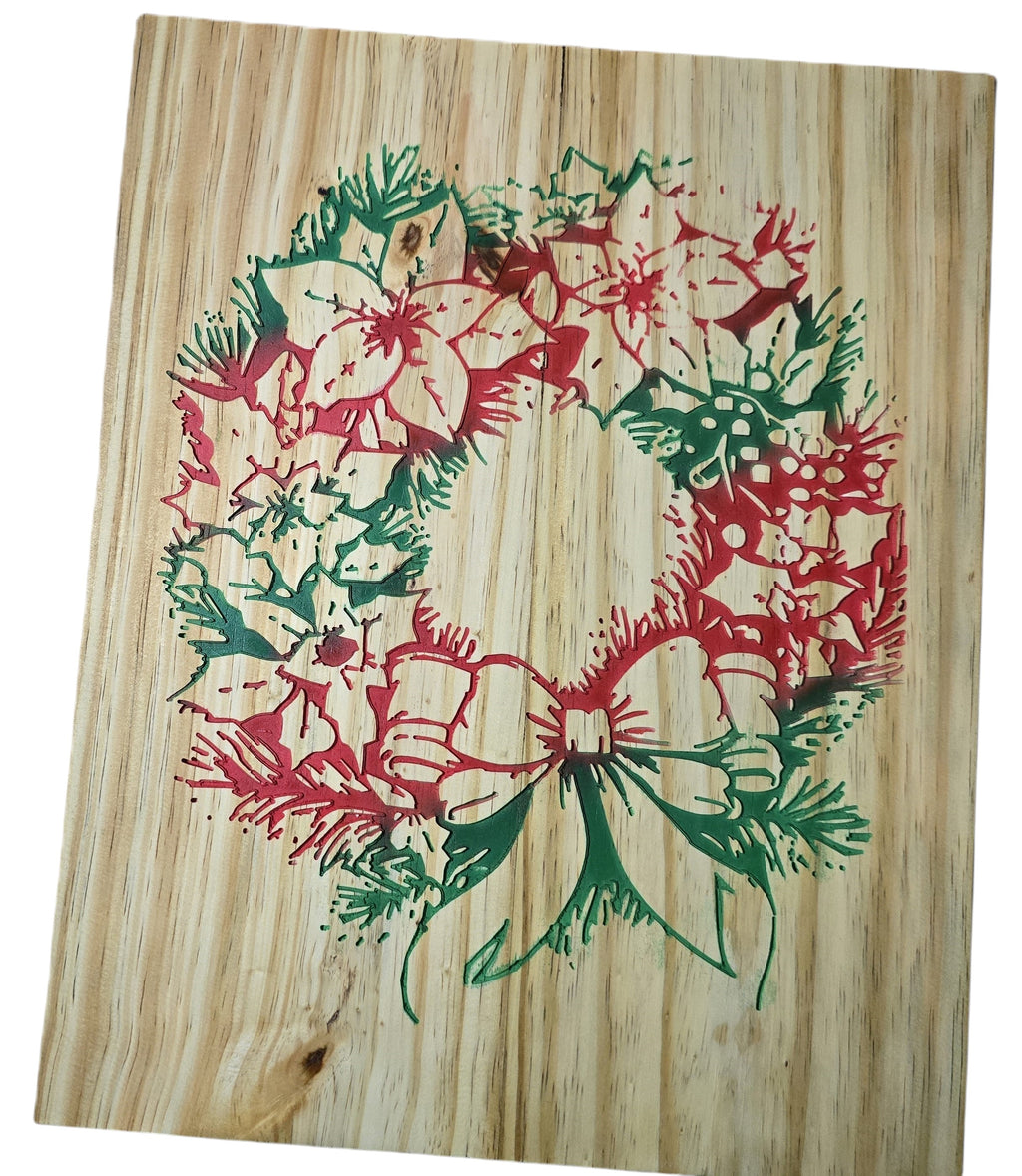 TK Wood Designs rustic Christmas wreath on wood, featuring red poinsettias and green pine boughs with a bow.
