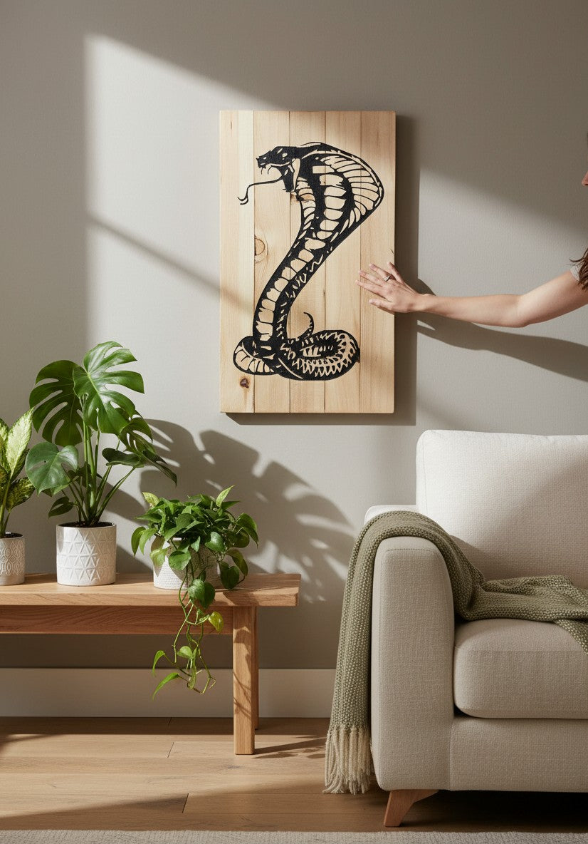 TK Wood Designs natural wood wall art featuring a black silhouette of a striking cobra with its hood flared.