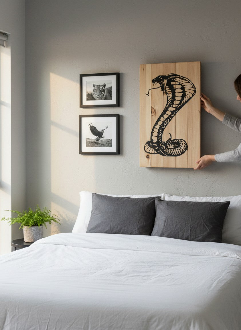 TK Wood Designs natural wood wall art featuring a black silhouette of a striking cobra with detailed scales and fangs.