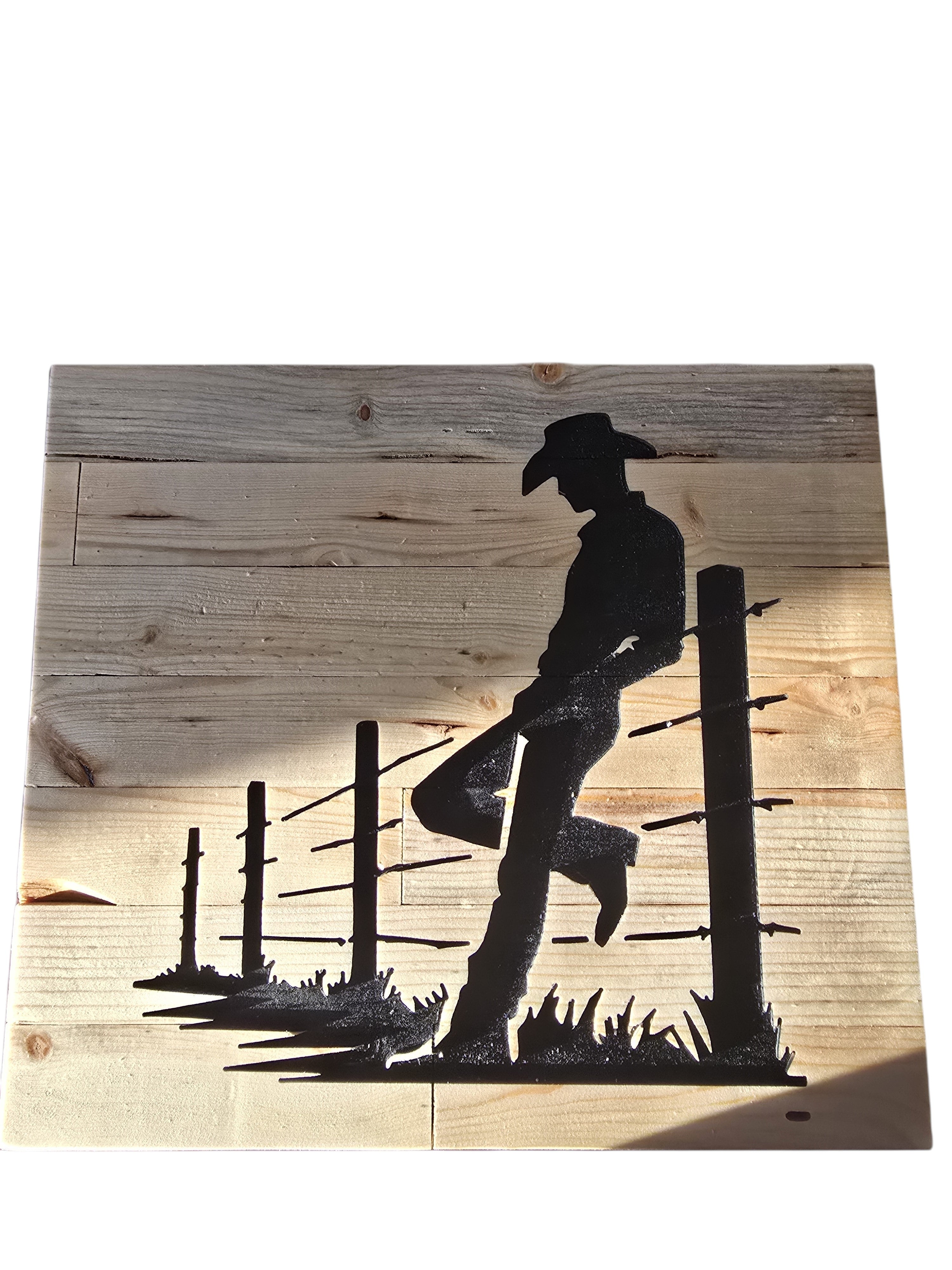 TK Wood Designs rustic wood sign featuring a black silhouette of a cowboy leaning on a fence, with distressed wood planks.