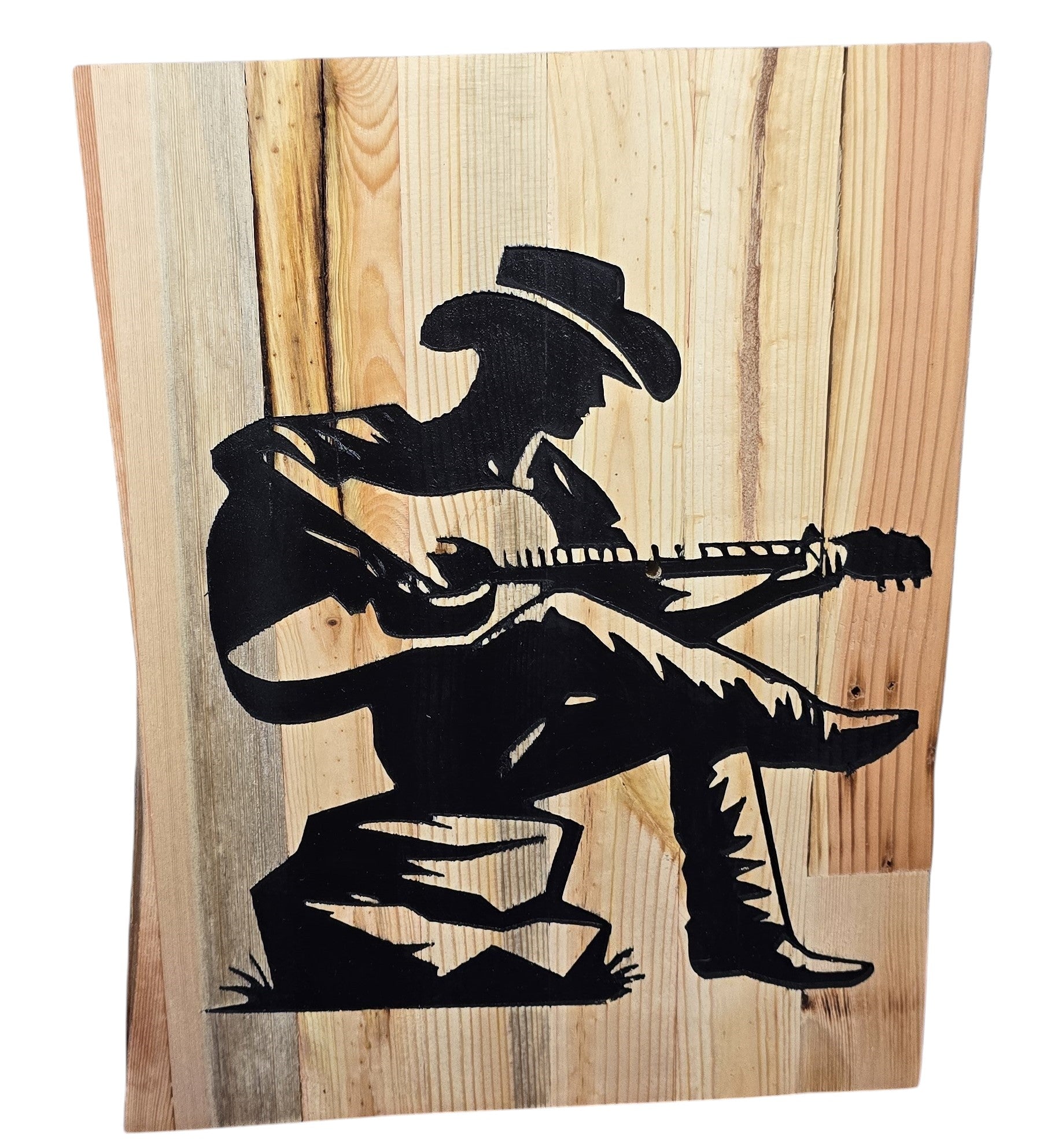 TK Wood Designs rustic reclaimed wood sign featuring a black silhouette of a cowboy playing guitar, seated on a rock.