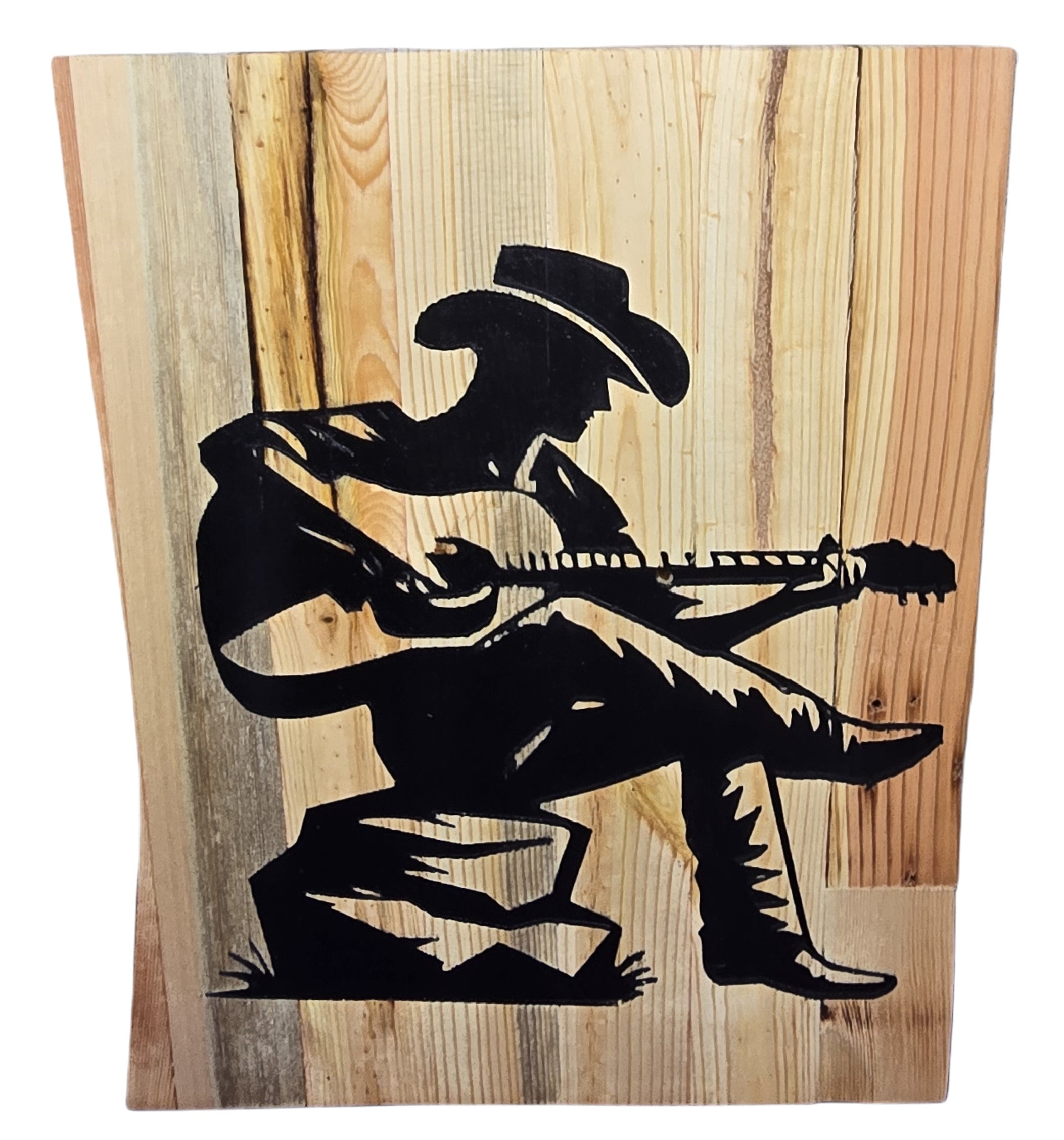 TK Wood Designs reclaimed wood sign featuring a black silhouette of a cowboy playing guitar, seated on a rock.