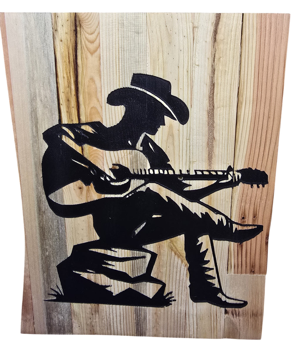 TK Wood Designs rustic reclaimed wood sign featuring a black silhouette of a cowboy playing guitar. Natural wood grain and weathered patina.