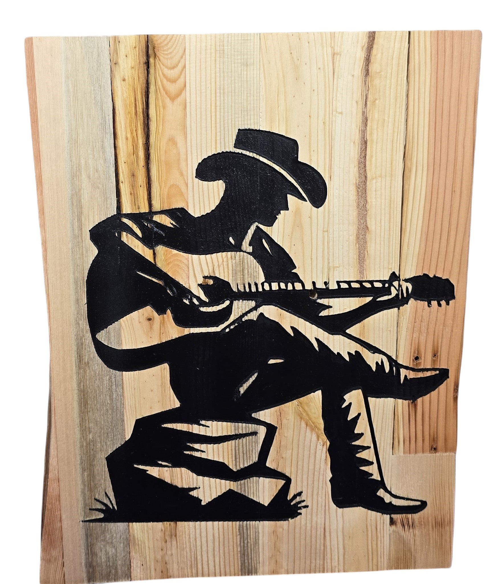 TK Wood Designs rustic reclaimed wood sign of a cowboy silhouette playing guitar, seated on a rock.