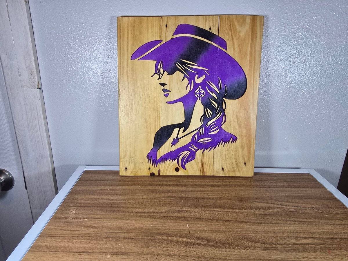 TK Wood Designs handcrafted wooden sign featuring a purple silhouette of a cowgirl in a hat on natural wood grain.