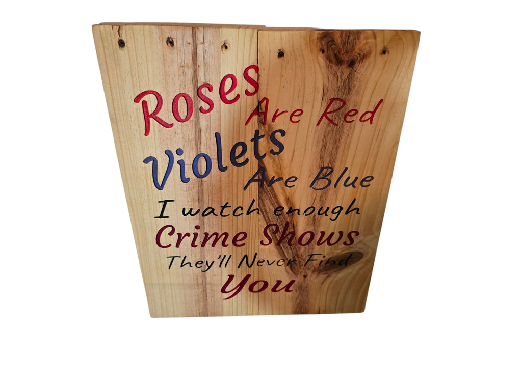 TK Wood Designs natural wood sign with red and blue text reading "Roses Are Red Violets Are Blue I watch enough Crime Shows They'll Never Find You".