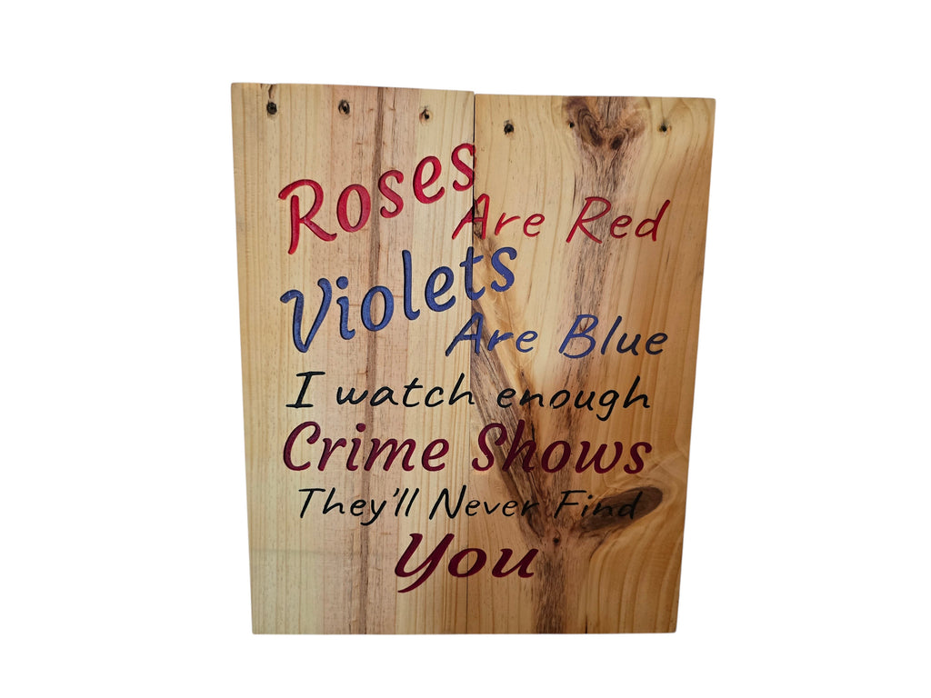 TK Wood Designs natural wood sign with red and blue text reading "Roses Are Red Violets Are Blue I watch enough Crime Shows They'll Never Find You."