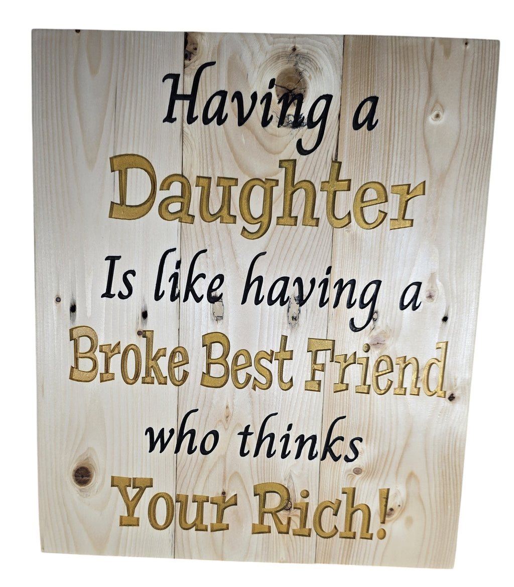 TK Wood Designs natural wood wall art with quote "Having a Daughter Is Like Having a Broke Best Friend who thinks Your Rich!" in gold and black.