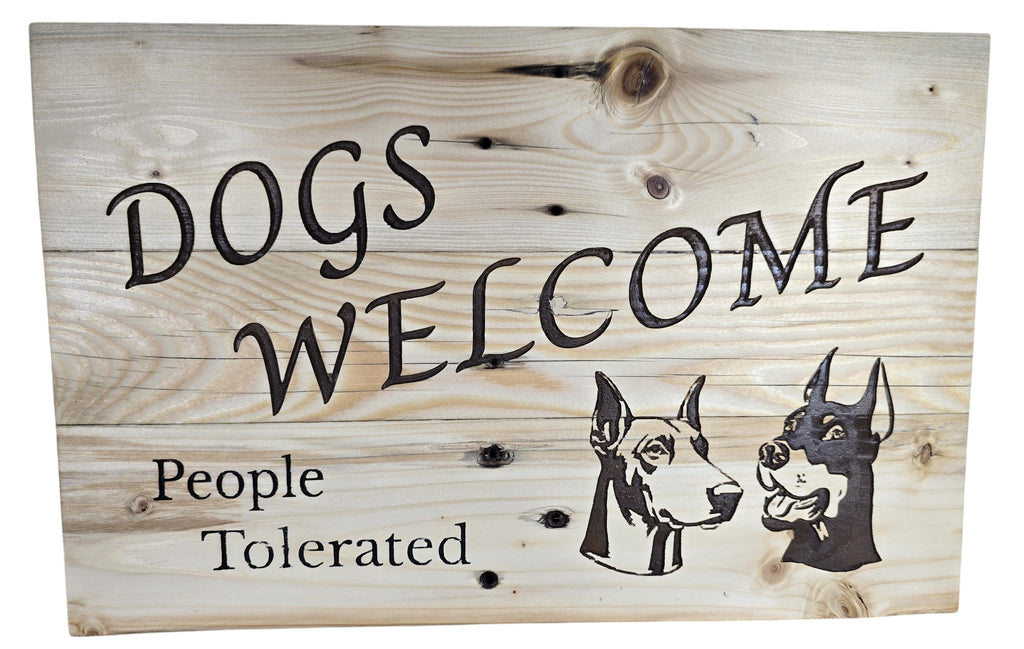 TK Wood Designs wooden sign with "Dogs Welcome, People Tolerated" text and two dog illustrations. Natural wood.