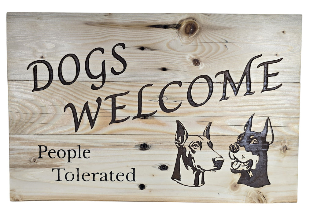 TK Wood Designs rustic wood sign with "Dogs Welcome, People Tolerated" text and Doberman dog illustrations.
