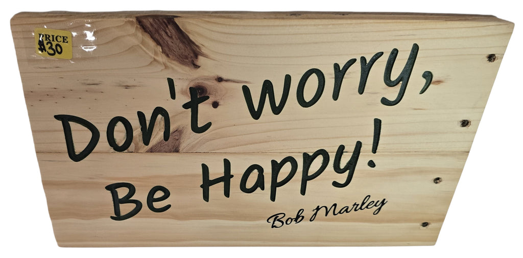TK Wood Designs natural wood sign with black handwritten-style lettering that says "Don't worry, Be Happy! Bob Marley".