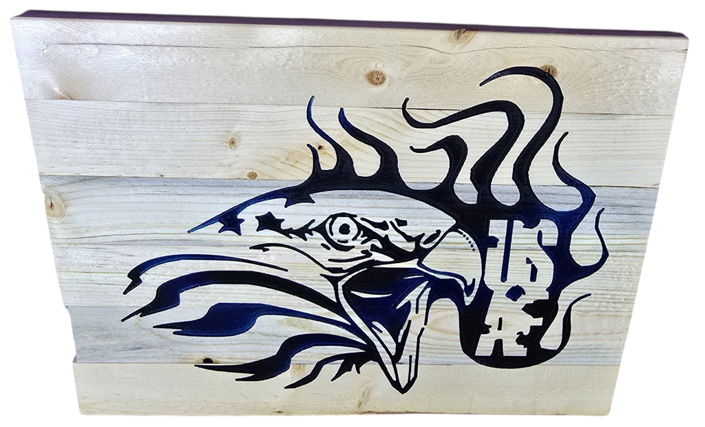 TK Wood Designs rustic navy blue eagle wall art on natural wood planks. Features stylized eagle with stars and flames.