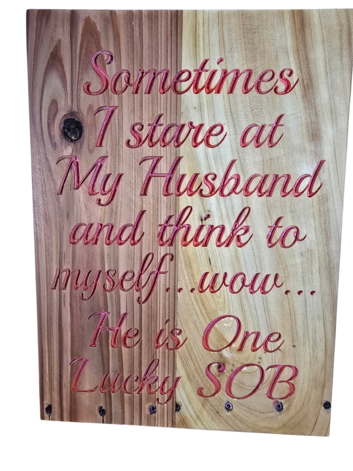 TK Wood Designs rustic wooden sign with red engraved text about a lucky husband on a natural wood grain background