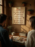 TK Wood Designs rustic engraved wooden sign for Mom hanging on a wall above a couple looking at a photo album