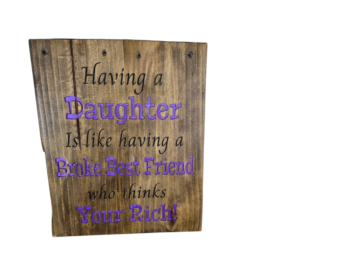 TK Wood Designs rustic wooden sign with engraved text about daughters in black and purple paint