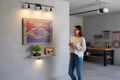 TK Wood Designs rustic wooden wall art featuring a fisherman silhouette against a vibrant sunset gradient in a home.