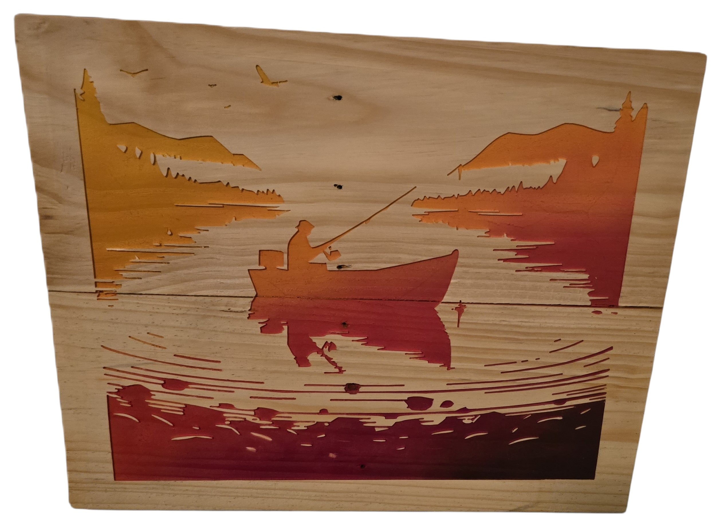 TK Wood Designs wooden wall art featuring a fishing scene with a lone angler in a boat at sunset, gradient orange and red.