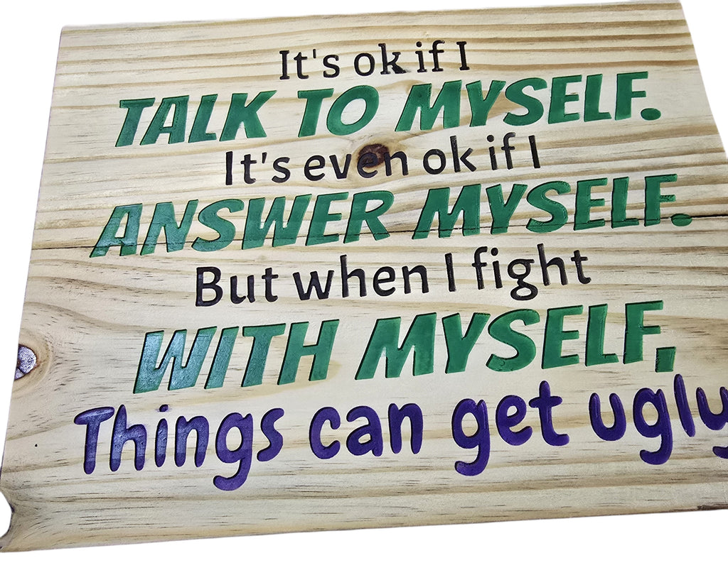 TK Wood Designs natural wood sign with carved text: "It's ok if I talk to myself. It's even ok if I answer myself. But when I fight with myself, Things can get ugly." Green and purple lettering.