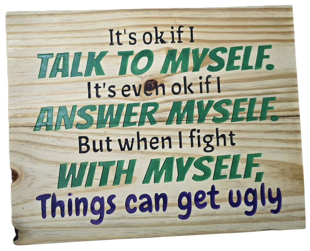 TK Wood Designs natural wood sign with engraved text: "It's ok if I talk to myself. It's even ok if I answer myself. But when I fight with myself, Things can get ugly." Green and purple text.
