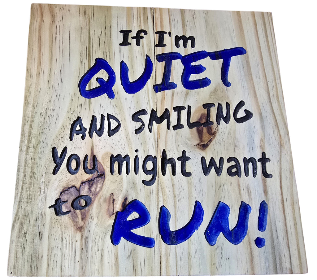 TK Wood Designs natural wood wall art with bold blue lettering that reads "If I'm Quiet and Smiling, You Might Want to Run!"