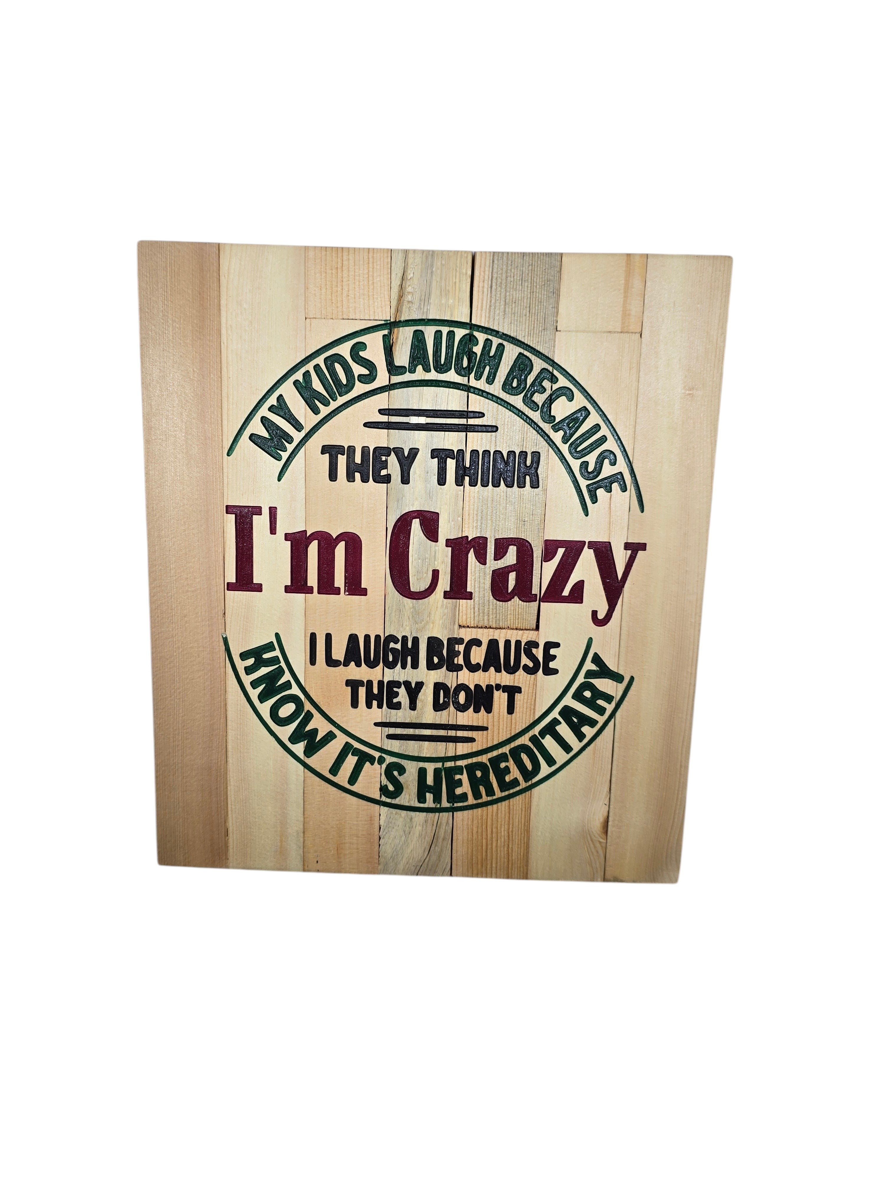 TK Wood Designs rustic wooden sign with text 'My kids laugh because they think I'm crazy. I laugh because they don't know it's hereditary.'