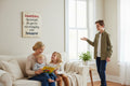 TK Wood Designs rustic wooden wall sign with humorous quote about grandchildren displayed in a cozy living room.
