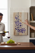 TK Wood Designs handcrafted wooden sign with carved purple grapes and leaves on a light wood background.