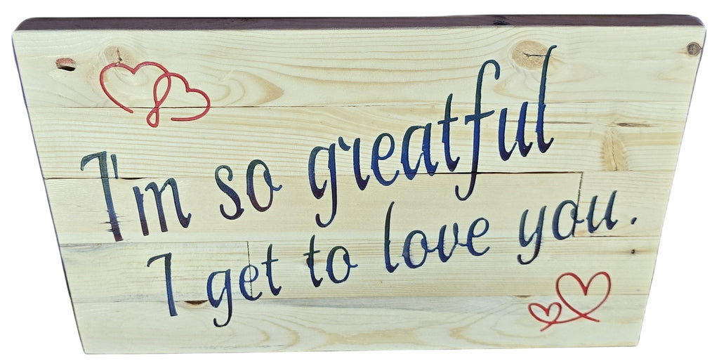 TK Wood Designs natural wood sign with navy blue script saying "I'm So Grateful I Get To Love You" and red heart accents.