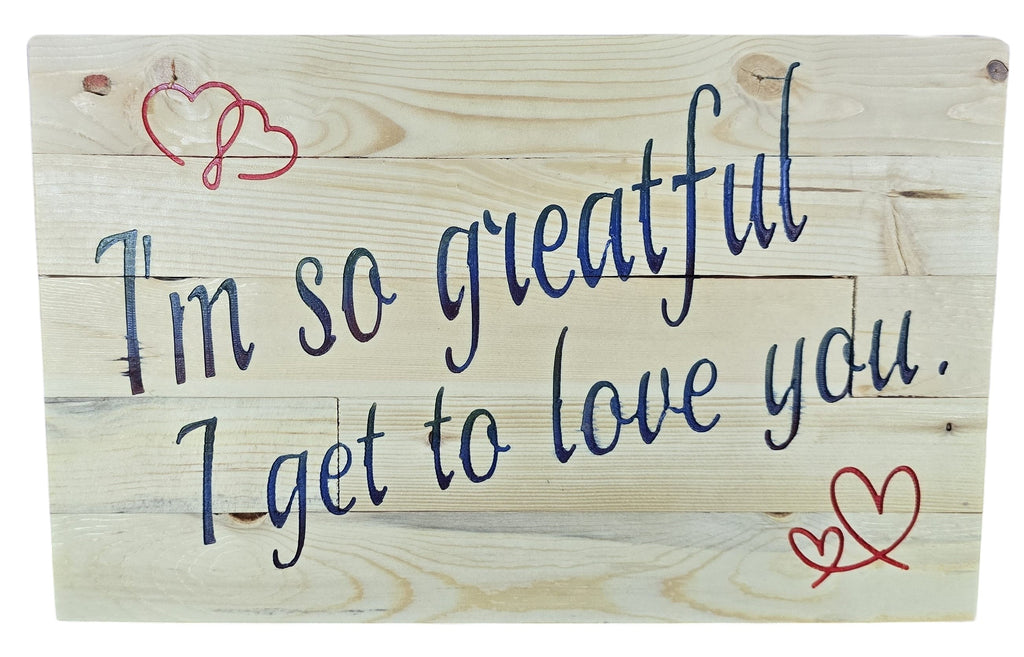 TK Wood Designs natural wood sign with navy blue script saying "I'm so grateful I get to love you." accented with red hearts.