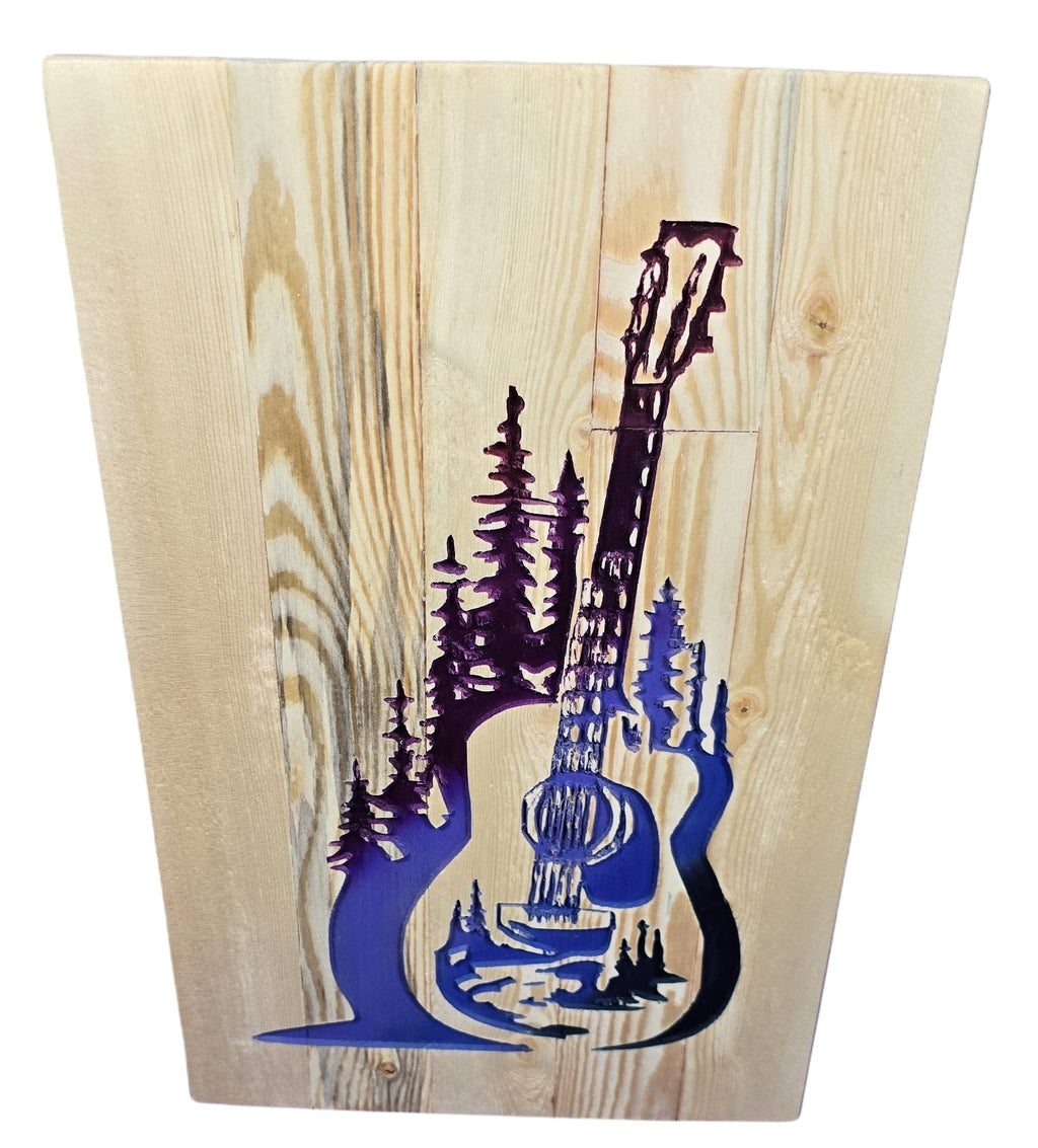 TK Wood Designs handcrafted wooden guitar sign with purple forest silhouette inlay, natural wood grain.
