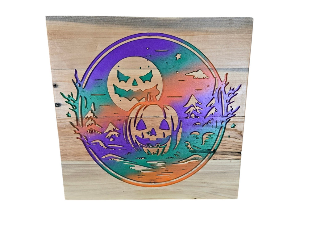 TK Wood Designs square wooden sign featuring a laser-cut Halloween pumpkin and moon scene with vibrant gradient paint