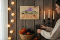 TK Wood Designs rustic wooden Happy Halloween wall sign featuring a witch hat and bat graphics in a cozy autumn room.
