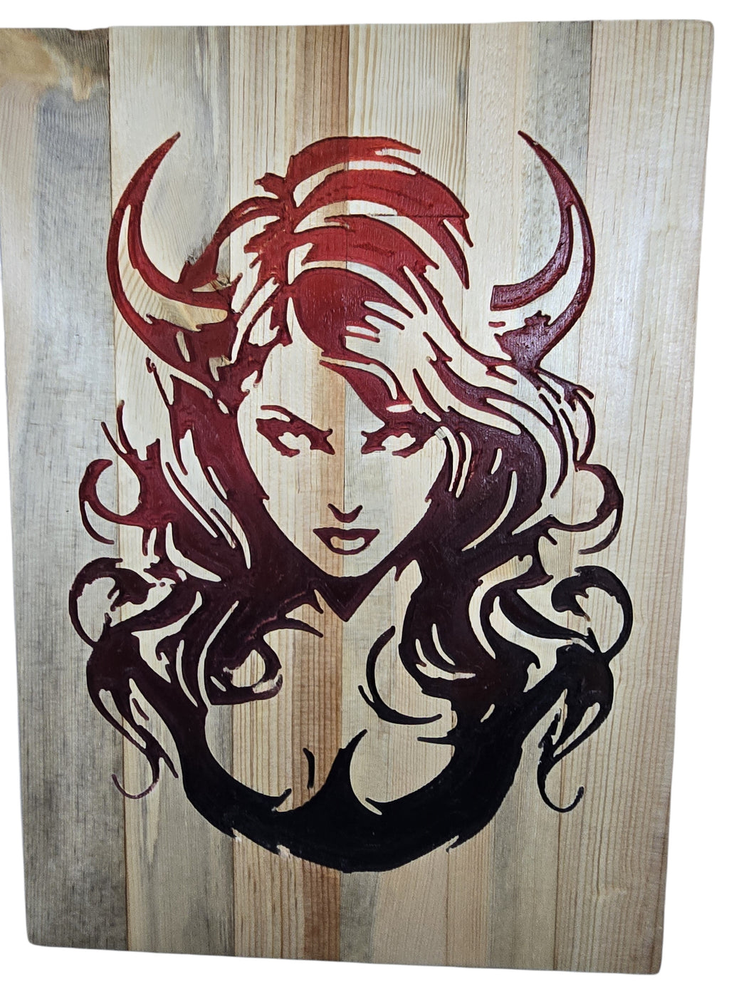 TK Wood Designs horned woman wood wall art in deep red and black on natural wood planks.