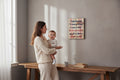 TK Wood Designs rustic wooden wall sign with a humorous parenting quote hanging in a cozy home interior.