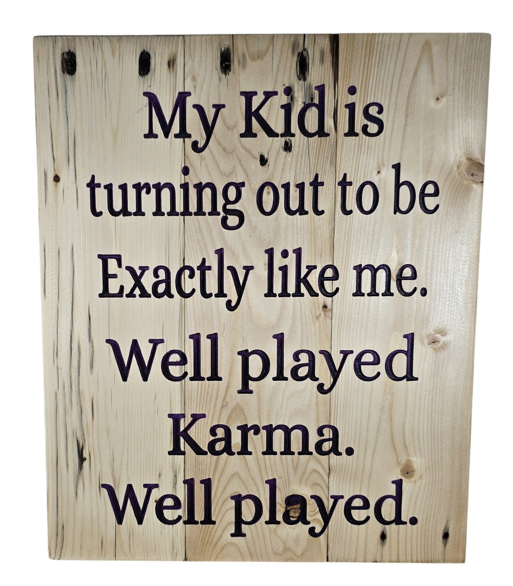TK Wood Designs wooden sign with dark purple text reading "My Kid is turning out to be Exactly like me. Well played Karma. Well played."