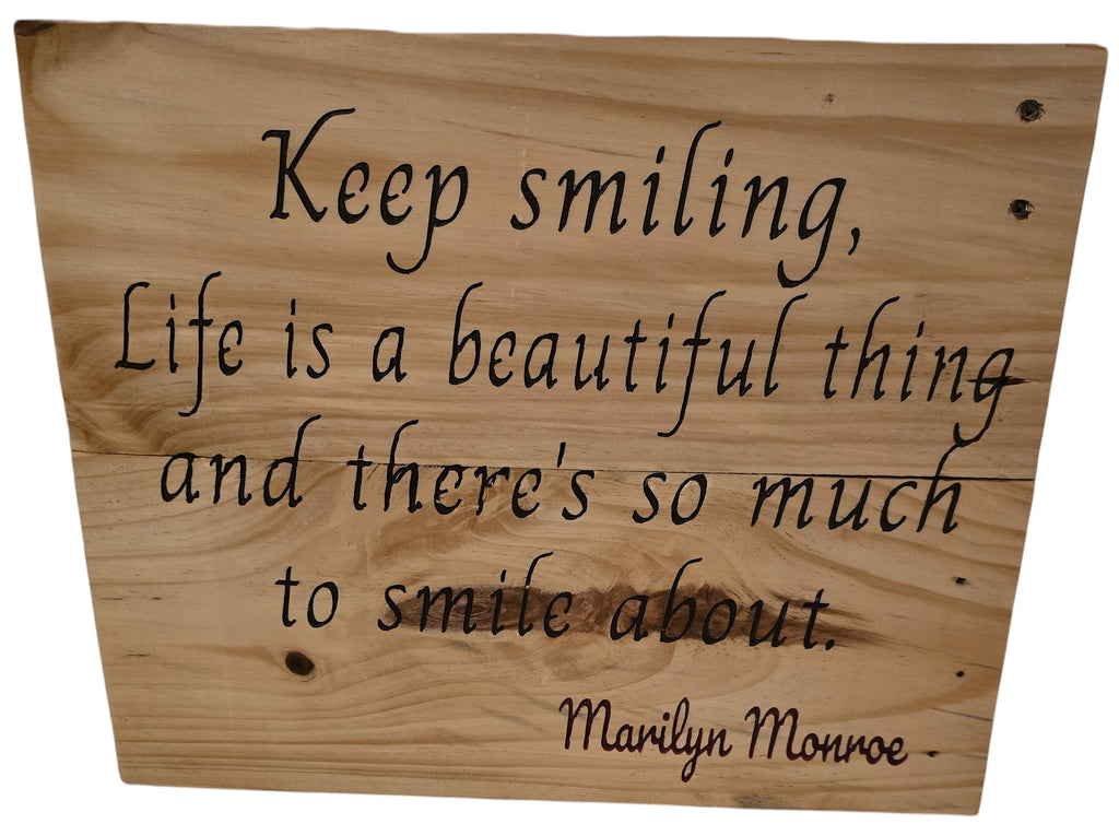 TK Wood Designs natural wood sign with carved lettering: "Keep smiling, Life is a beautiful thing and there's so much to smile about." - Marilyn Monroe.