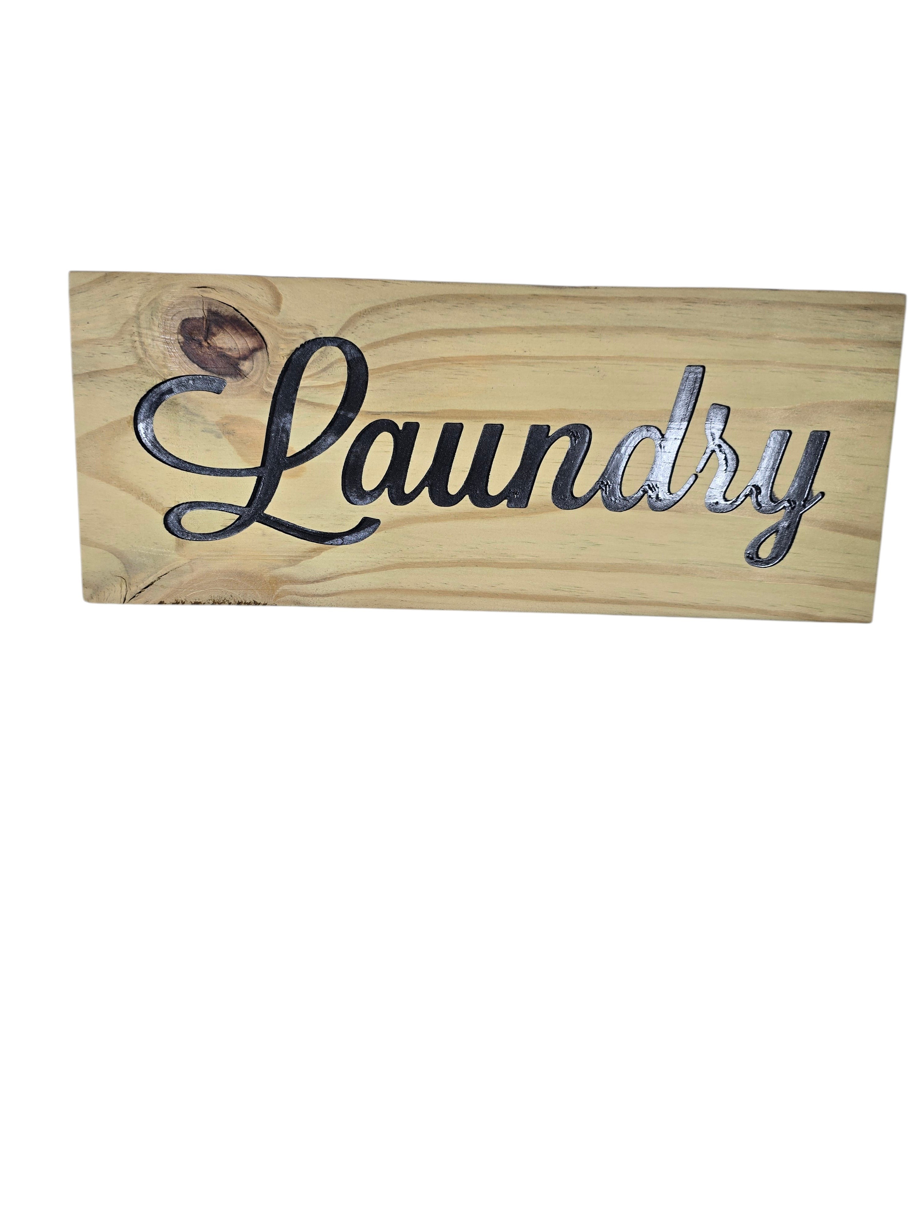 TK Wood Designs rustic light wood sign with carved black script lettering that says Laundry.